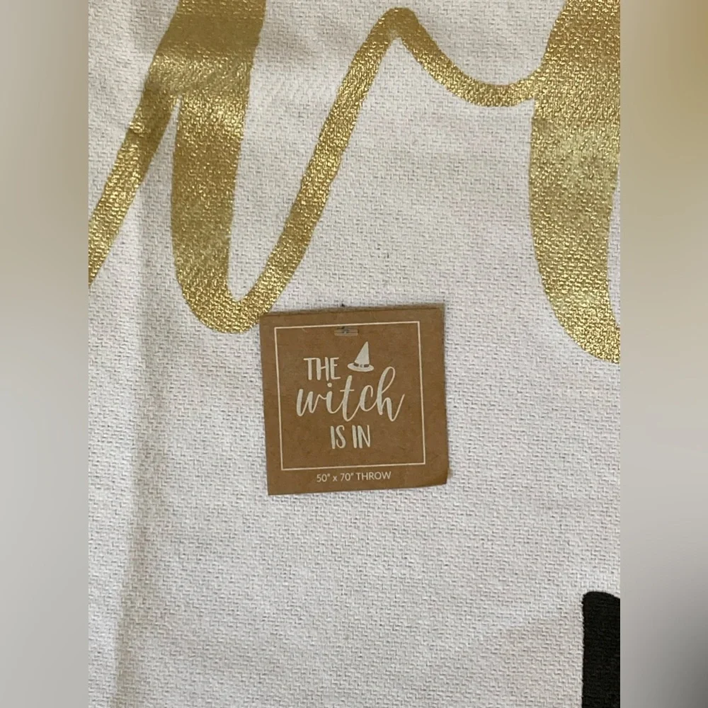 “The Witch Is In” by mudpie White Throw Blanket